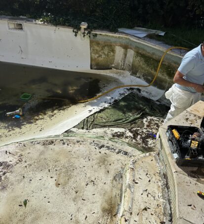 a man standing next to a pool