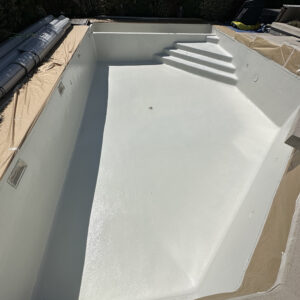 a pool being constructed with a white cover