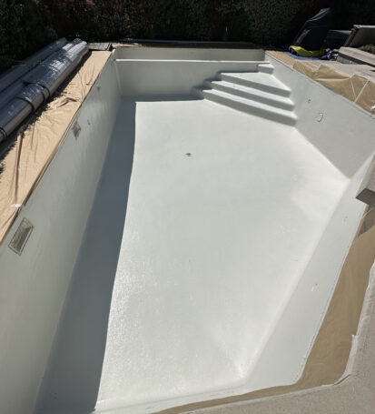 a pool being constructed with a white cover