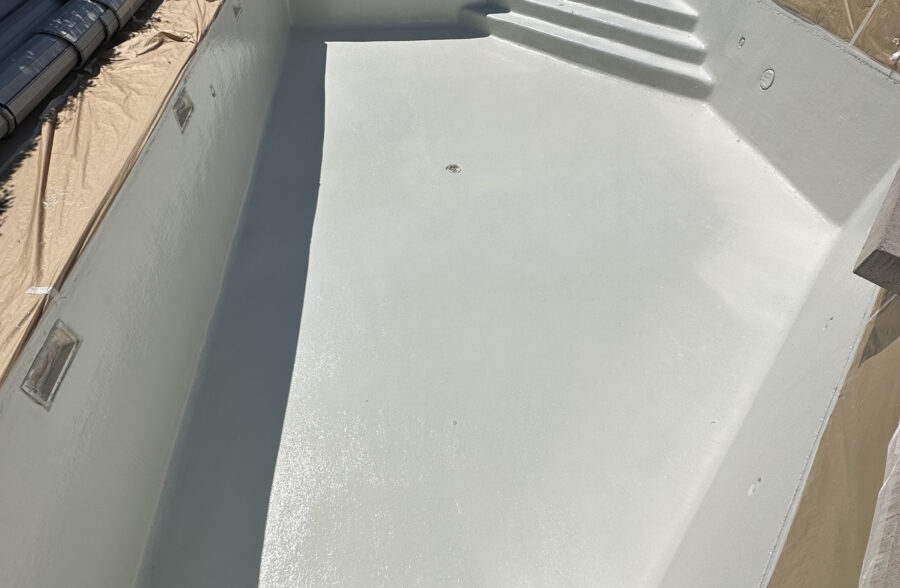 a pool being constructed with a white cover