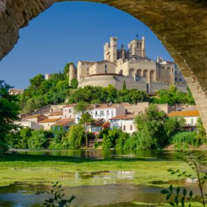 a bridge over water with a castle on top of it